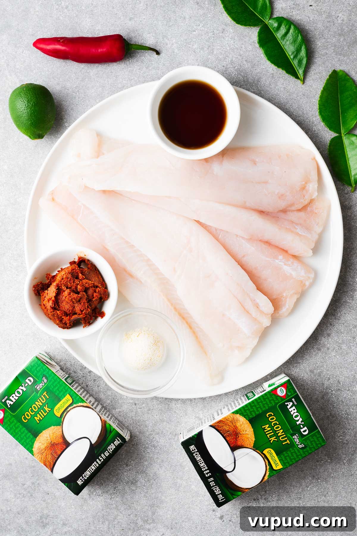 Authentic Thai Red Curry with Fish: Quick Flavorful Recipe 3 Ingredients for making Thai red curry with fish and coconut milk, including white fish fillets, red curry paste, fish sauce and coconut milk.