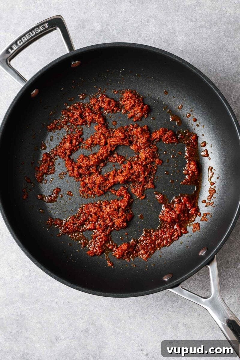 Authentic Thai Red Curry with Fish: Quick Flavorful Recipe 5 Stir-frying Thai red curry paste in olive oil.