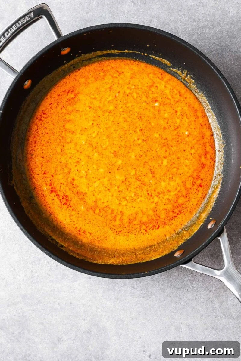 Authentic Thai Red Curry with Fish: Quick Flavorful Recipe 6 Simmering the coconut curry sauce.