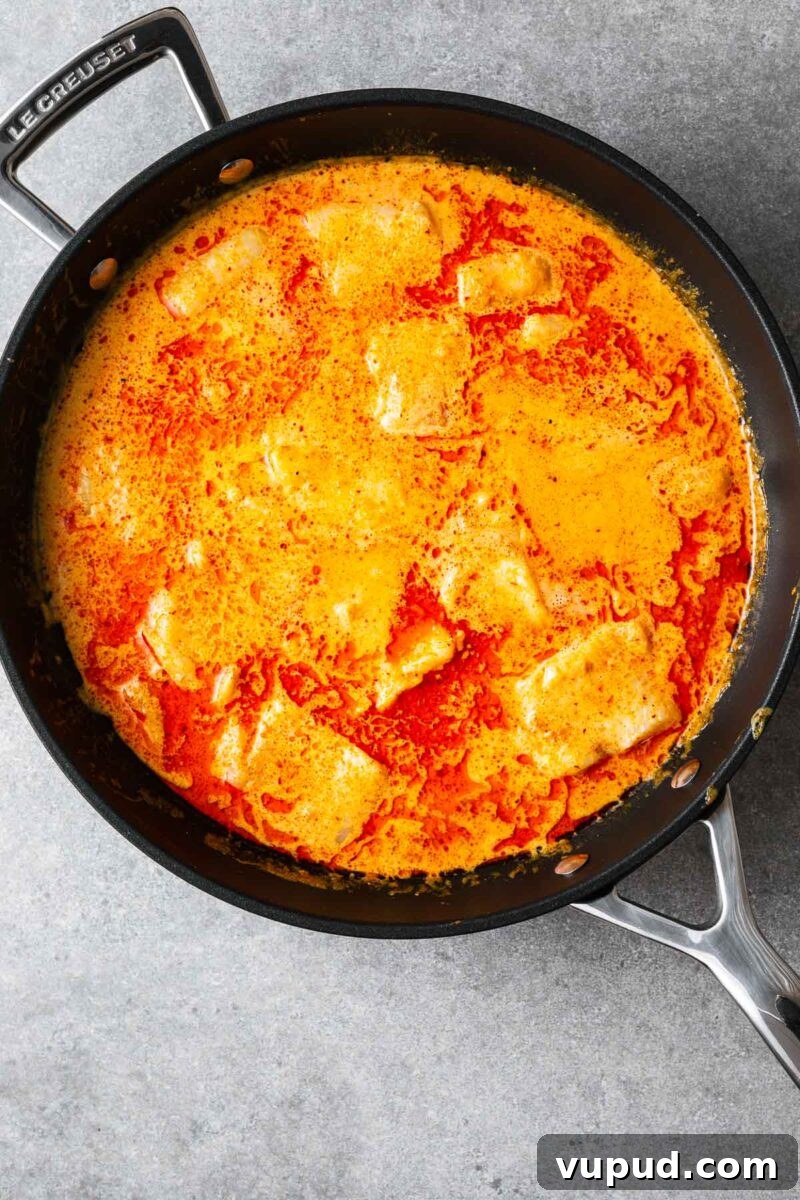 Authentic Thai Red Curry with Fish: Quick Flavorful Recipe 9 Large even-sized chunks of white fish cooked in a red curry coconut sauce.