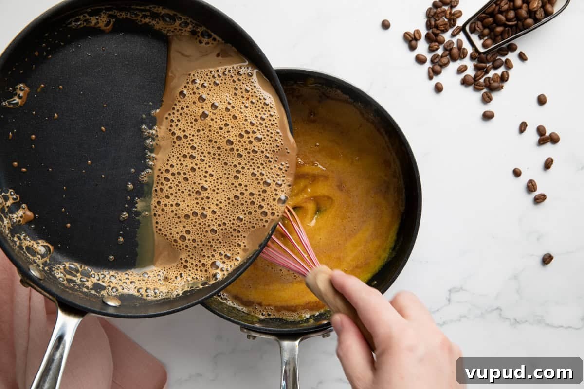 Homemade Espresso Ice Cream Recipe: Rich Coffee Gelato at Home 4 Egg yolks being tempered with warm espresso milk.
