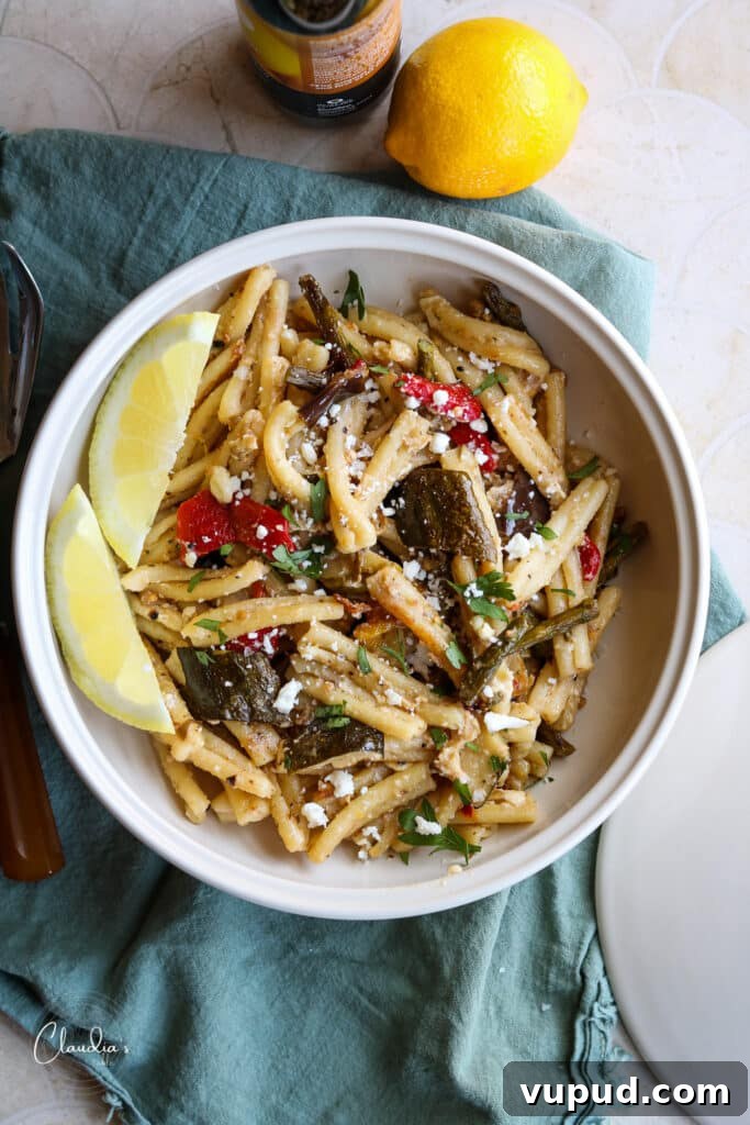 Grilled Vegetable Pasta with Feta and Lemon 2 pasta with veggies, feta and lemon in white bowl with lemon wedges