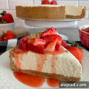 No-Bake Strawberry Cheesecake with Fresh Strawberries 5 no-bake strawberry cheesecake on a white serving plate. Cheesecake is topped with fresh strawberry topping