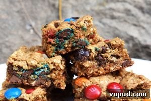 Chewy Monster Cookie Bars with M&Ms and Chocolate Chips 2 Monster Cookie Bars are a twist on the classic chewy peanut butter, oat and M&M cookies. They’re turned into bars to make them even denser!