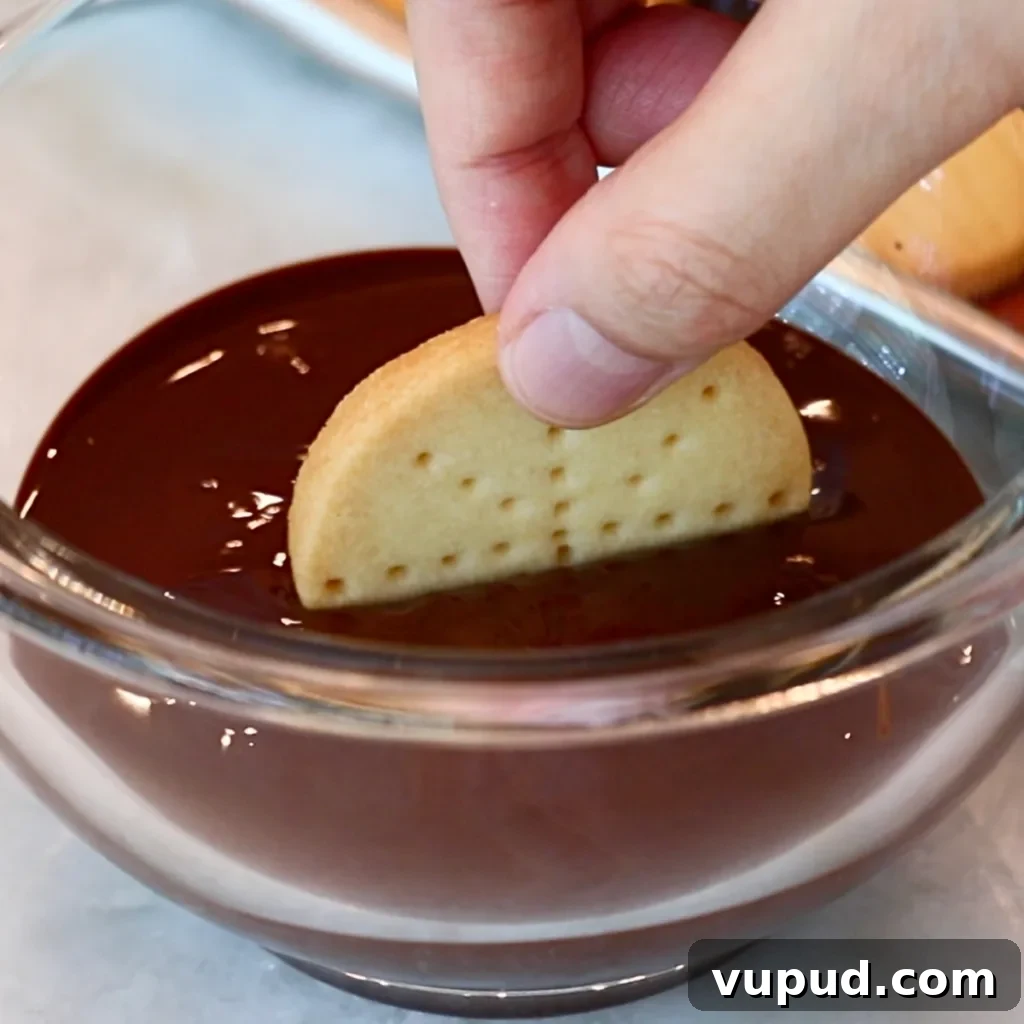 Classic Buttery Shortbread Cookies Recipe for Perfect Cookies 27 dipping shortbread cookie in dark chocolate