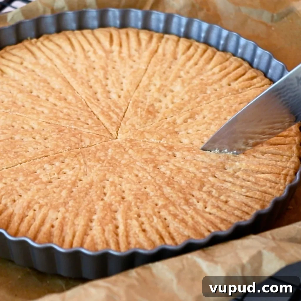 Classic Buttery Shortbread Cookies Recipe for Perfect Cookies 37 cutting baked shortbread cookies in a pan
