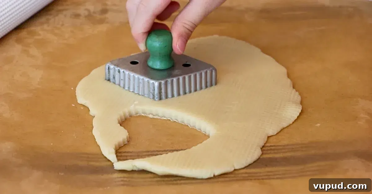 Classic Buttery Shortbread Cookies Recipe for Perfect Cookies 6 cutting cookie dough with a vintage cookie cutter.