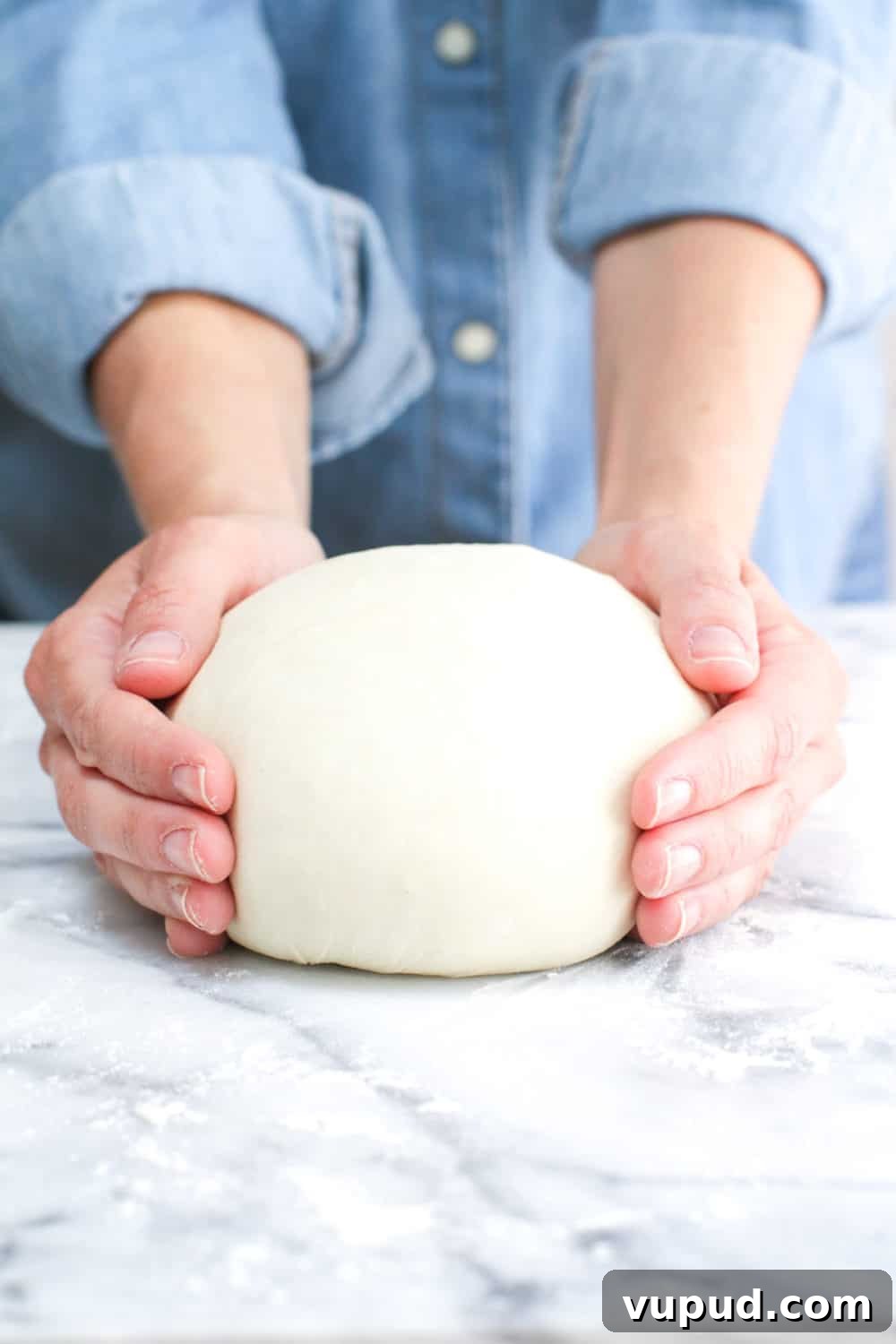 72-Hour Pizza Dough Recipe from Baking Steel 9 rolling pizza dough into a boule