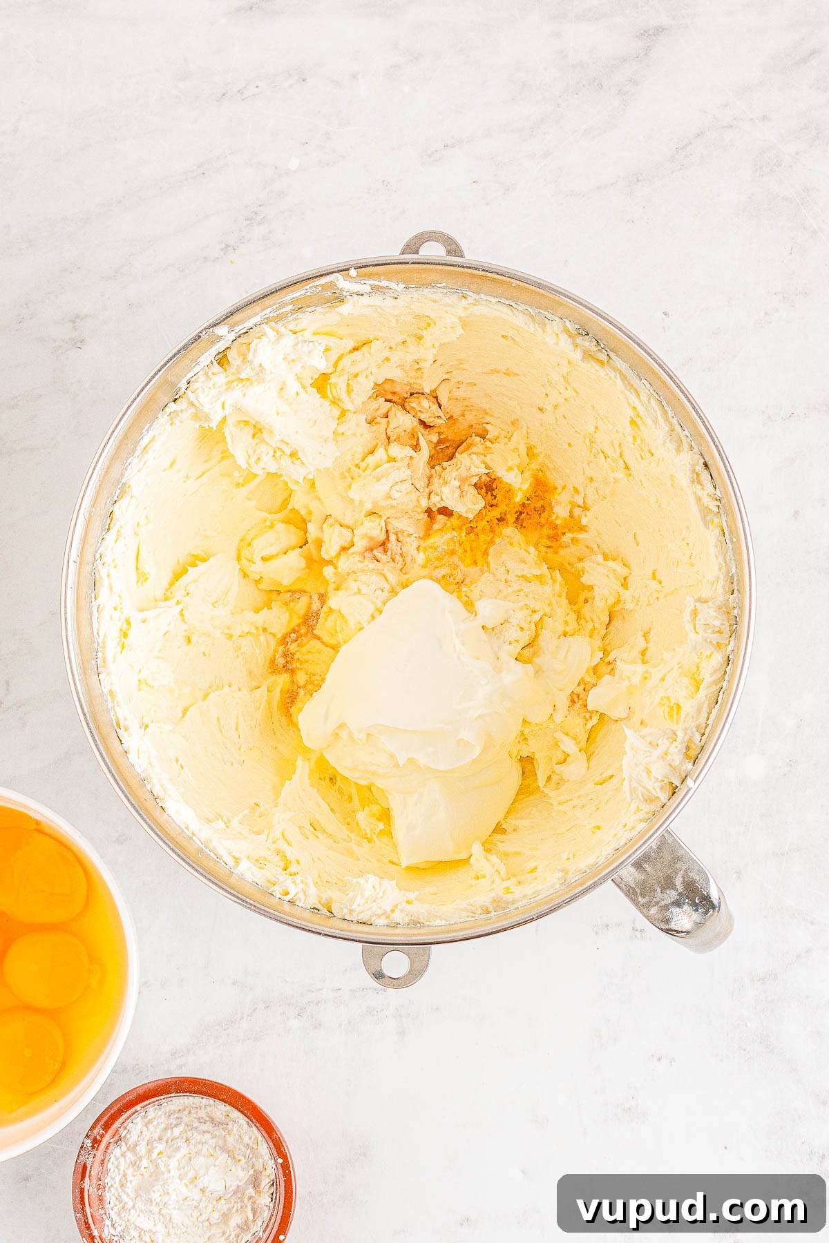 Classic New York Cheesecake Recipe: Creamy Oven-Baked Slice 13 Cheesecake filling ingredients in a bowl.
