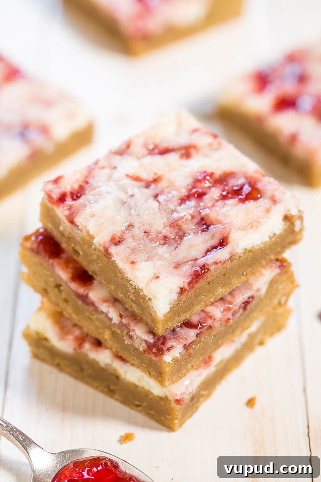 Classic New York Cheesecake Recipe: Creamy Oven-Baked Slice 30 A stack of three Strawberry Cheesecake Bars.