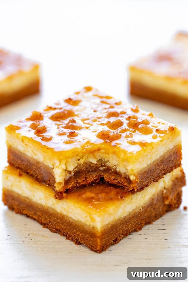 Classic New York Cheesecake Recipe: Creamy Oven-Baked Slice 31 Two Crème Brûlée Cheesecake Bars stacked on top of each other, the top bar missing a bite.
