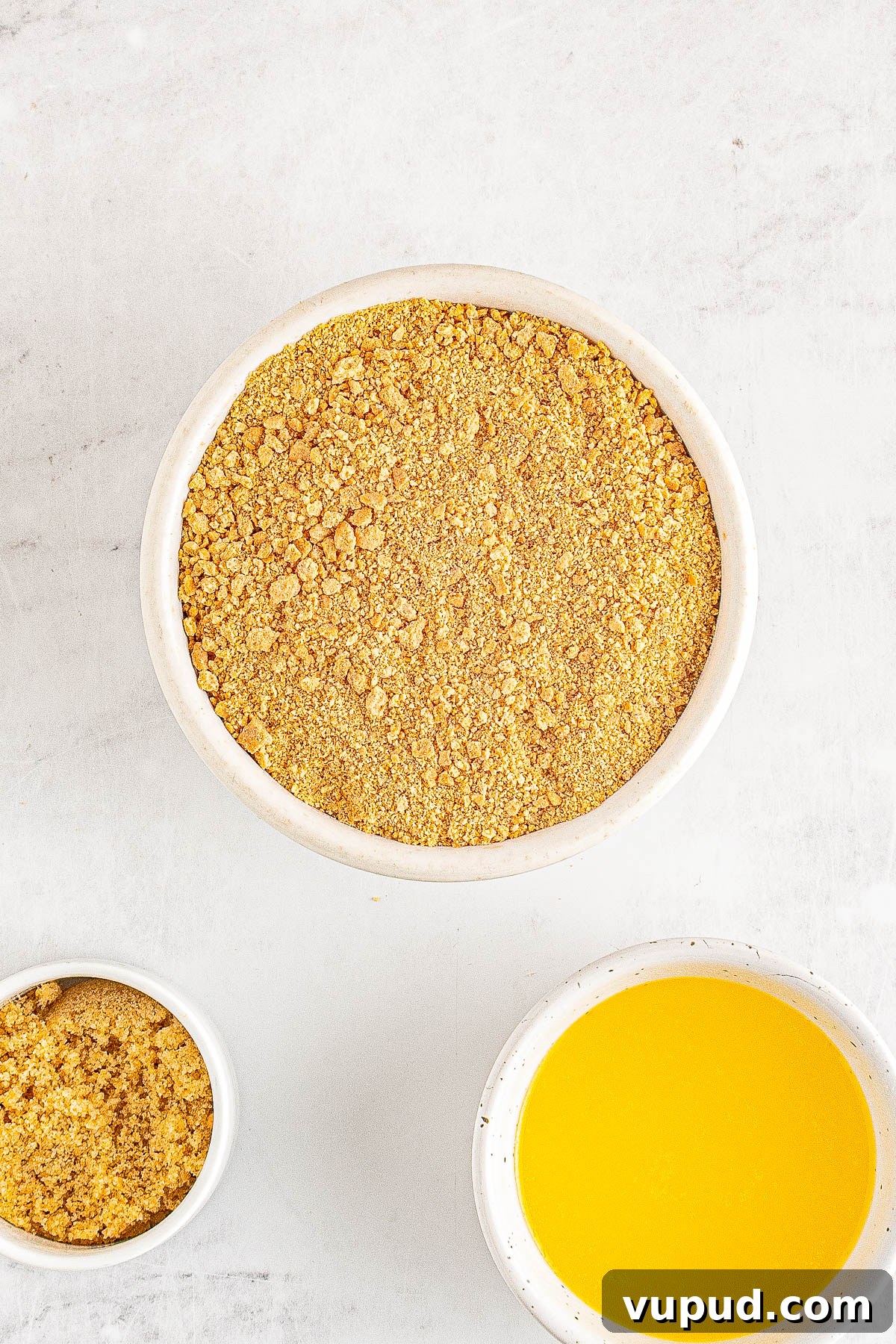 Classic New York Cheesecake Recipe: Creamy Oven-Baked Slice 5 Bowls of graham cracker crumbs, melted butter, and brown sugar.