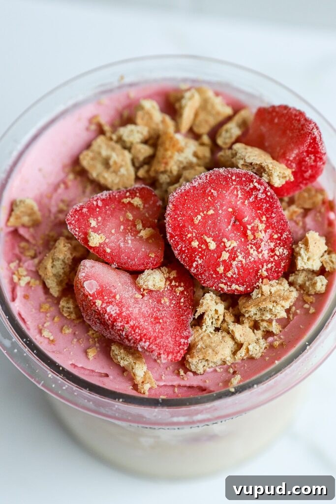 Strawberry Cheesecake Protein Ice Cream Recipe (Ninja Creami) 2 strawberry cheesecake ninja creami protein ice cream in pint container